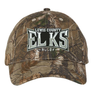 Introducing the Lewis County Elks Realtree Camo Cap by EMB S&S Activewear—a classic adjustable hat featuring “Lewis County Elks Rugby” embroidered in white and gray on the front, showcasing a timeless Realtree Xtra pattern for exceptional style and comfort.