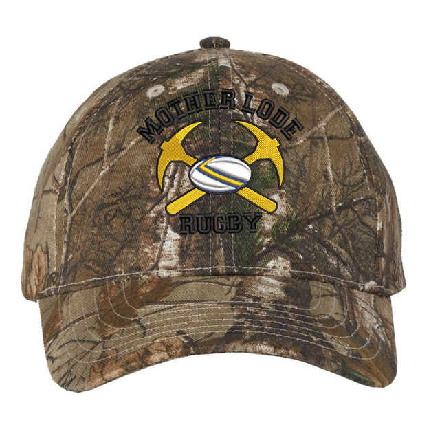 Mother Lode Realtree Camo Cap featuring an adjustable closure and an embroidered emblem of two crossed yellow pickaxes, a rugby ball, and the text “Mother Lode Rugby.”