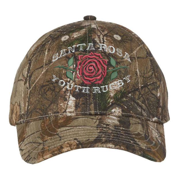 The Santa Rosa Youth Rugby Realtree Camo Cap by EMB S&S Activewear features Realtree Xtra camo, a red rose, and “Santa Rosa Youth Rugby” embroidered on the front. This adjustable hat blends rugged outdoor style with team pride.