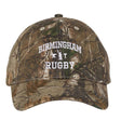Introducing the Birmingham Rugby Text Logo Realtree Camo Cap by EMB S&S Activewear, featuring “Birmingham Rugby” embroidered in white across the front and an embroidered team logo for a classic, sporty look.