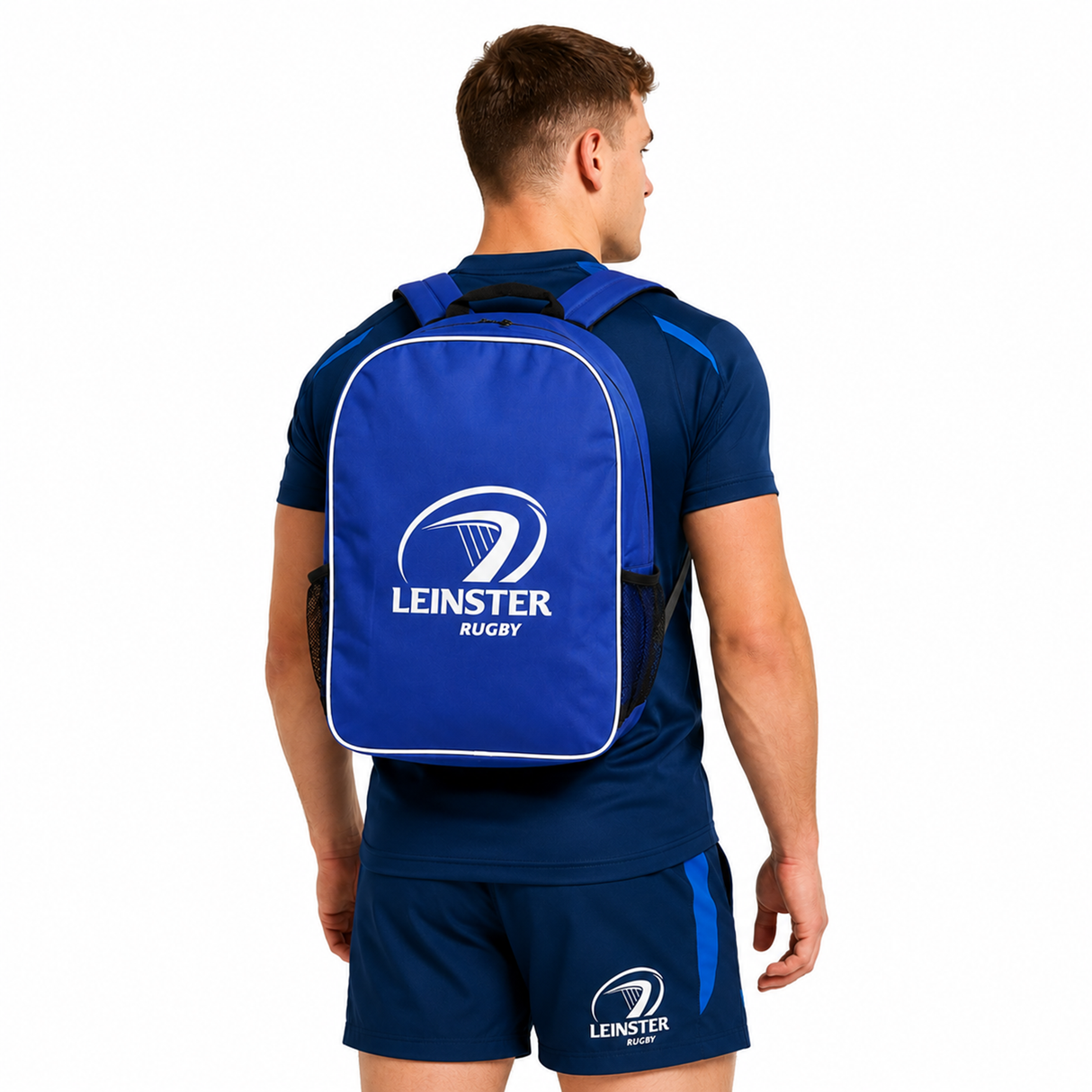A man in blue athletic wear faces away, sporting the Castore Leinster Backpack 24/25 with the team logo and name printed in white.