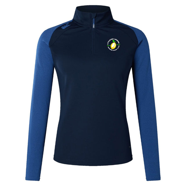 The Littleton Women Rugby Club Women's Elite First Layer by EMB Canterbury is a navy long-sleeve athletic pullover with lighter blue sleeves, VapoDri moisture-wicking tech, quarter-zip collar, and a tennis ball logo with text on the left chest.
