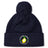 The Littleton Women Rugby Club Pom Pom Beanie by Canterbury features navy blue fleece lining, a pom-pom, and the club's yellow lemon logo on the front cuff. Brand: EMB Canterbury.