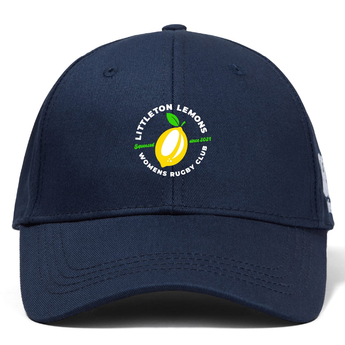 The EMB Canterbury Littleton Women Rugby Club Flexfit Drill Cap features a navy blue curved brim, yellow lemon graphic, and "Littleton Lemons Women's Rugby Club" embroidered on the front.