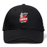 The Lincoln City Youth Rugby Flexfit Drill Cap by EMB Canterbury is a black curved brim cap featuring a red rugby ball and white building logo on the front.