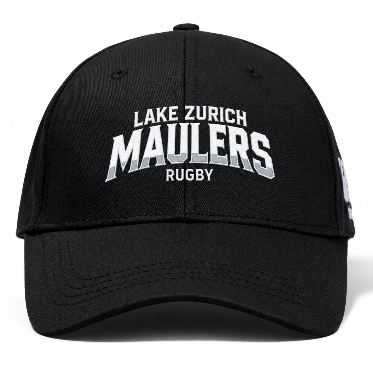 Lake Zurich Flexfit Drill Cap by Canterbury in black, featuring white and gray embroidered text that reads “LAKE ZURICH MAULERS RUGBY” across the front.