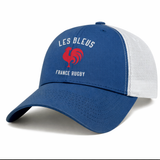 The Les Bleus France Rugby Retro Trucker Cap by EMB S&S Activewear features "LES BLEUS FRANCE RUGBY" and a red rooster logo on the front, making it ideal for fans supporting Les Bleus.