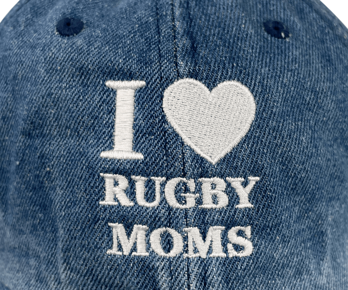The Modish Rugger I Heart Rugby Moms Cap features "I ♥ RUGBY MOMS" in white on blue denim, providing a comfortable fit for everyday wear.