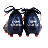 Rear view of New Balance 442 v2 Elite FG Wide Boots in Navy/Energy Red, featuring the brand logo on the heel and a premium leather upper.