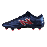 The New Balance 442 v2 Elite FG Wide Boots in Navy/Energy Red feature stylish red and white detailing with a bold "N" logo—ideal for soccer or rugby players seeking performance and standout design.