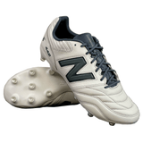 A pair of New Balance Wide 442 V2 Pro FG soccer cleats in Concrete, Grey Matter, and Blacktop colorway with black laces and prominent "N" logos, expertly crafted from premium leather. Featuring multiple firm ground studs for optimal traction, one cleat is standing upright while the other lies on its side.