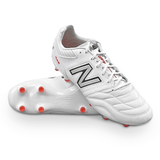 The New Balance Wide 442 v2 Pro Synthetic FG in White/Silver features prominent New Balance branding on the side, orange studs for firm ground, and a sleek white exterior.