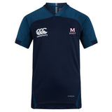 The San Joaquin Memorial Vapodri Evader Jersey by EMB Canterbury features navy blue short sleeves, light blue shoulder panels, "Canterbury" logo on the right chest, "M Rugby" emblem on the left chest, and moisture-wicking Vapodri technology.