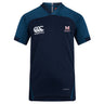 The San Joaquin Memorial Vapodri Evader Jersey by EMB Canterbury features navy blue short sleeves, light blue shoulder panels, "Canterbury" logo on the right chest, "M Rugby" emblem on the left chest, and moisture-wicking Vapodri technology.
