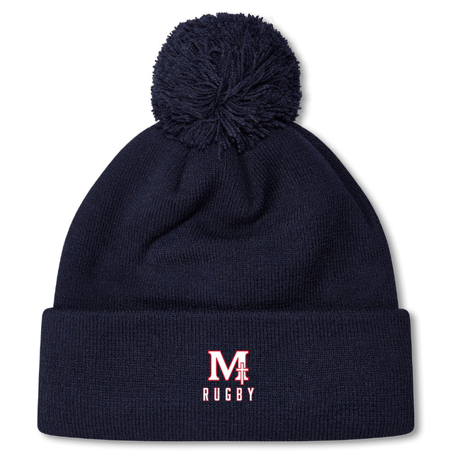 Stay warm in style with the San Joaquin Memorial Pom Pom Beanie by EMB Canterbury, featuring navy blue fleece lining, a top pom-pom, and an embroidered red and white "M Rugby" logo on the front cuff.