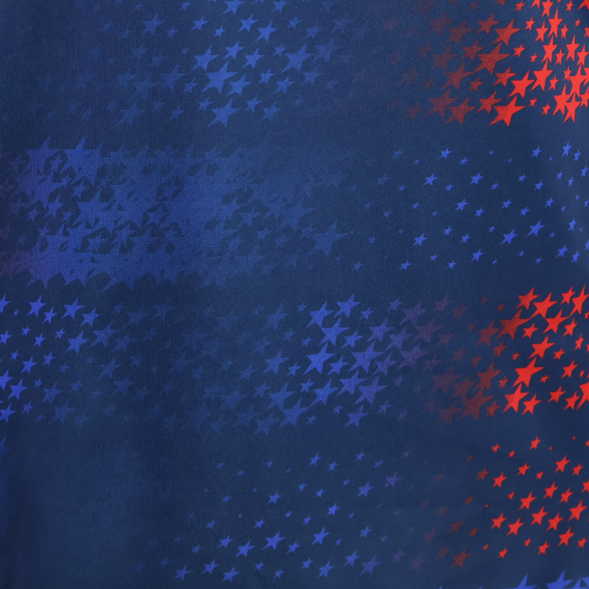 Blue background with a scattered pattern of light blue and red stars transitioning across the image—perfect for showcasing the USA Rugby 25/26 Away Replica Jersey by Macron.