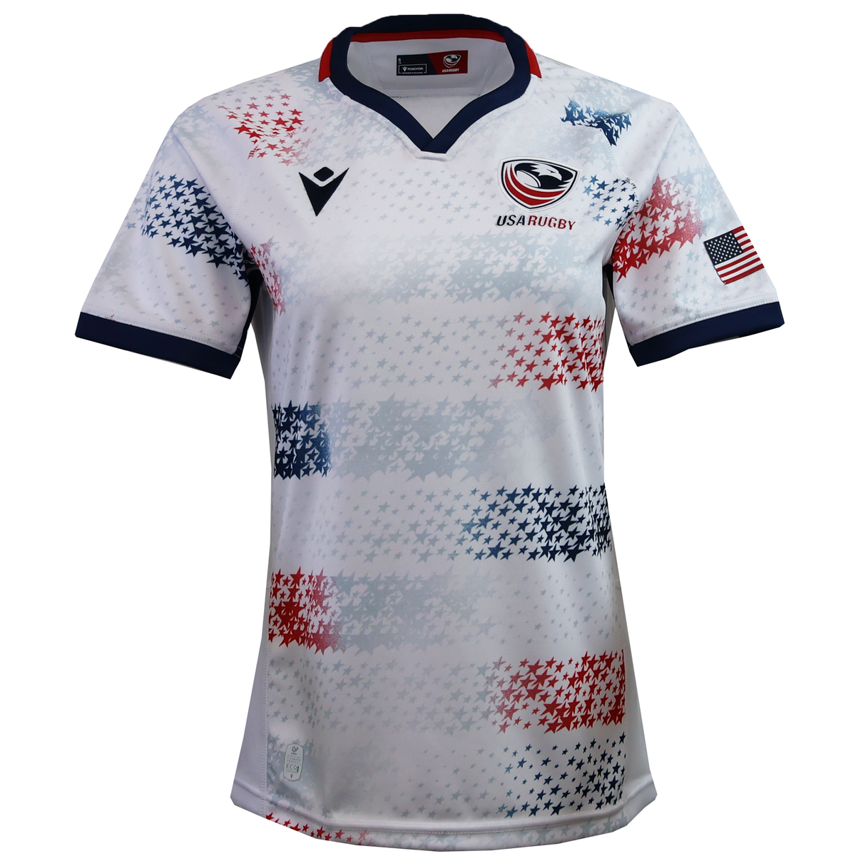 Women's USA Rugby 25/26 Home Replica Jersey by Macron features a navy collar and cuffs, blue and red star patterns, USA Rugby chest logo, and an American flag sleeve patch. Perfect for fans seeking authentic USAR style.