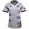Women's USA Rugby 25/26 Home Replica Jersey by Macron features a navy collar and cuffs, blue and red star patterns, USA Rugby chest logo, and an American flag sleeve patch. Perfect for fans seeking authentic USAR style.