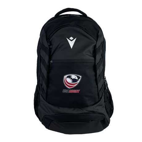 The USA Rugby 25 Athletes Backpack by Macron features a black design with a white chevron emblem on the upper front pocket, ergonomic back straps for comfort, and is shown against a white background.