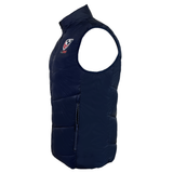 The USA Rugby 25/26 Padded Gilet by Macron features a navy blue, water-resistant design with a high collar, front zipper, side pockets, and a circular embroidered USA Rugby logo on the chest for all-weather comfort.