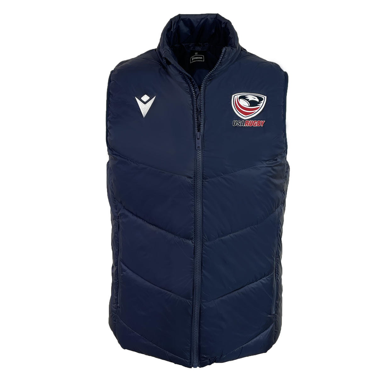 The USA Rugby 25/26 Padded Gilet by Macron is a navy blue, lightweight gilet with a high collar, featuring the USA Rugby logo on the left chest and a white Macron logo on the right.