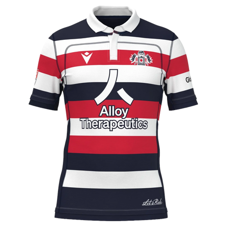 The New England Free Jacks MLR 25/26 Replica Home Jersey by Macron features red, white, and navy stripes, the Alloy Therapeutics logo, and a chest crest.