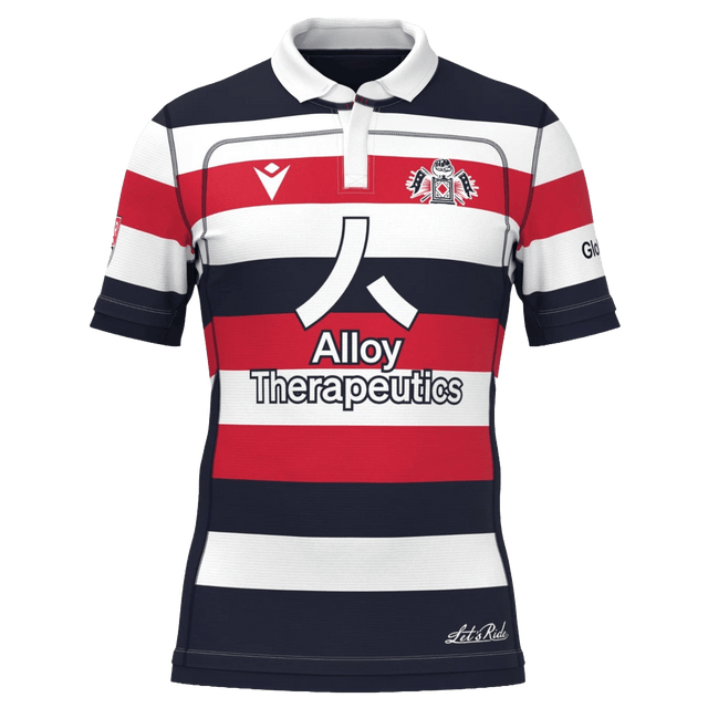 The New England Free Jacks MLR 25/26 Replica Home Jersey by Macron features red, white, and navy stripes, the Alloy Therapeutics logo, and a chest crest.