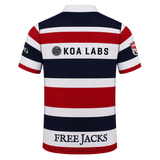 The New England Free Jacks MLR 25/26 Replica Home Jersey by Macron features red, white, and navy stripes, "KOA LABS" and "FREE JACKS" logos on the back, sponsor logos on the sleeves—an official replica jersey.
