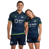 A man and woman wearing matching Seattle Seawolves MLR 25/26 Replica Home Jerseys by Macron, featuring WaFd Bank logos, stand together and smile at the camera.