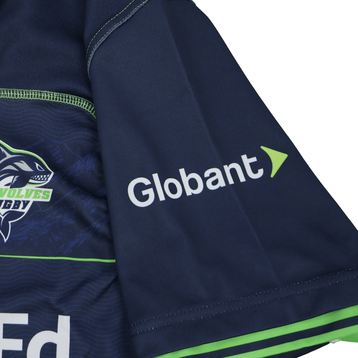 The Seattle Seawolves MLR 25/26 Replica Home Jersey by Macron features navy blue fabric, the Globant logo in white and green, a shark graphic, and "Wolves Rugby" text—a classic MLR home jersey from Macron.