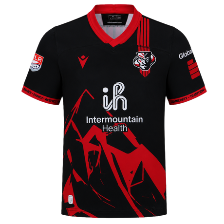 The Utah Warriors MLR 25/26 Replica Home Jersey by Macron features black and red colors, a stylized mountain design, team logo on the chest, "Intermountain Health" sponsor text, and official Major League Rugby detailing.