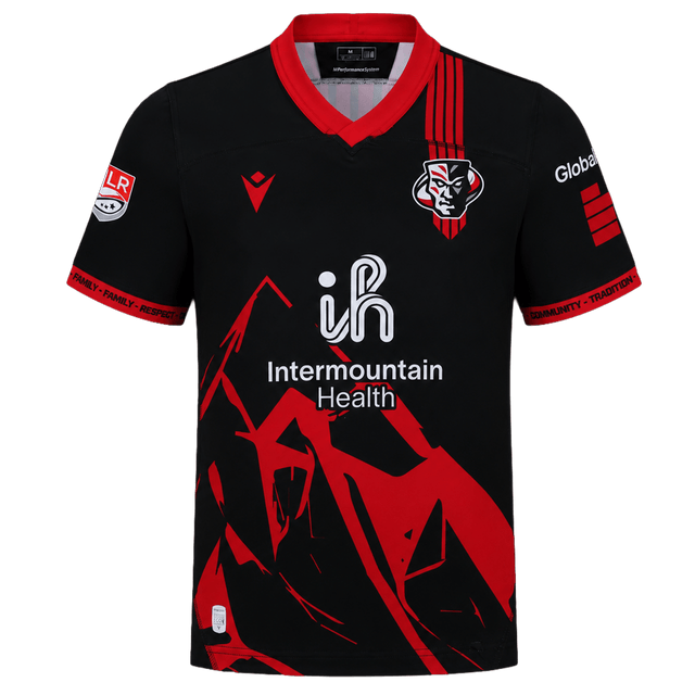 The Utah Warriors MLR 25/26 Replica Home Jersey by Macron features black and red colors, a stylized mountain design, team logo on the chest, "Intermountain Health" sponsor text, and official Major League Rugby detailing.