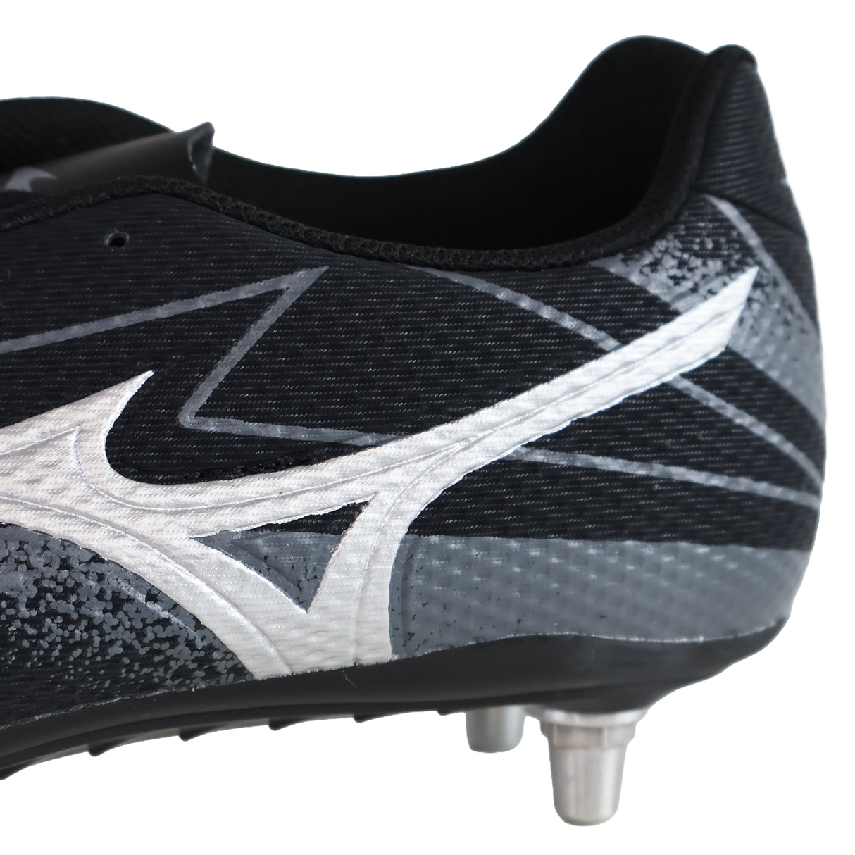 Close-up of the Mizuno Waitangi Pro SG Wide rugby boot in black and galaxy silver, featuring a white Mizuno logo and metal studs for superior soft ground performance.