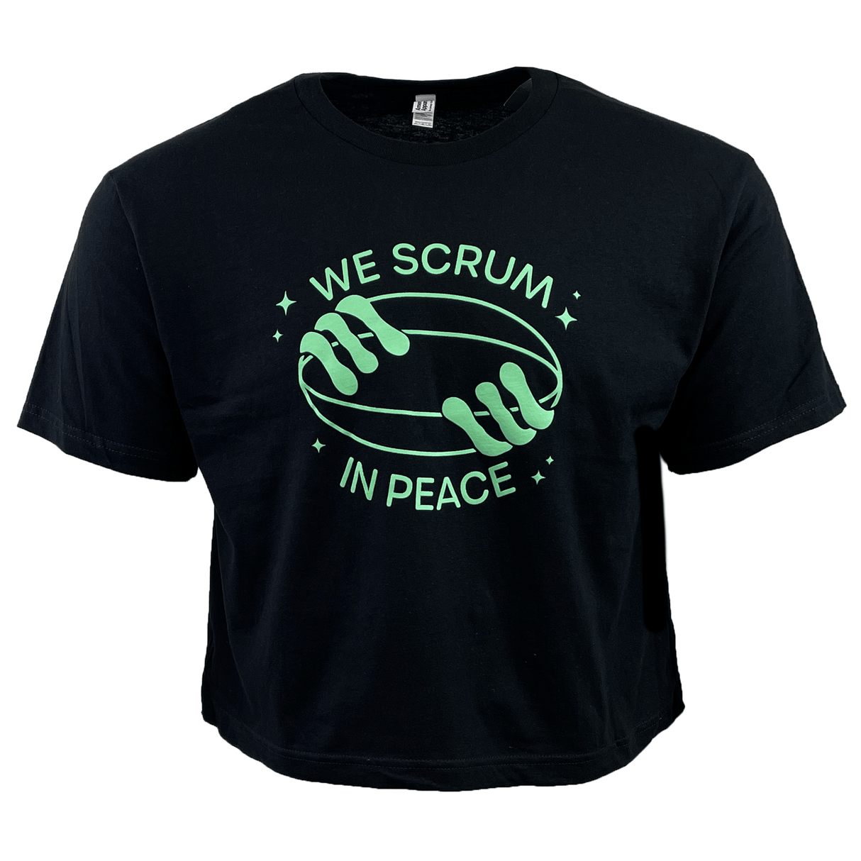 Introducing the Women's Modish Rugger Limited Edition "We Scrum in Peace" Crop Top Tee: a black top featuring two hands holding a rugby ball surrounded by stars, with the slogan printed in green—a must-have for dedicated rugby fans.