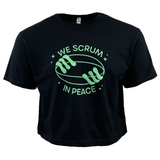 Introducing the Women's Modish Rugger Limited Edition "We Scrum in Peace" Crop Top Tee: a black top featuring two hands holding a rugby ball surrounded by stars, with the slogan printed in green—a must-have for dedicated rugby fans.
