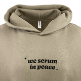 The Modish Rugger Limited Edition "We Scrum in Peace" Pullover Hoodie is a beige rugby hoodie with the text printed boldly in black on the front.