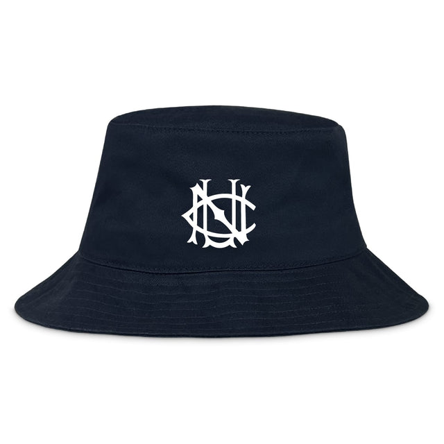 The UNC Rugby Crusher Bucket Cap by EMB S&S Activewear is a navy cotton hat with a white interlocking "NY" logo on the front, blending style and sun protection.
