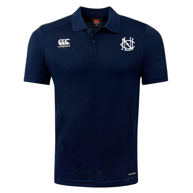 The UNC Rugby Club Dry Polo by EMB Canterbury is a navy blue short-sleeve polo with a collar, featuring white embroidered logos on the chest and shoulder. Made with breathable Vapodri technology for all-day comfort.