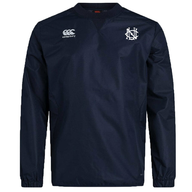 The UNC Rugby Club Vaposhield Contact Top by EMB Canterbury is a navy blue long-sleeve pullover featuring advanced Vaposhield technology, the Canterbury logo, and an interlocking white letter emblem on the chest.