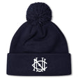 The UNC Rugby Pom Pom Beanie by EMB Canterbury is a navy fleece-lined beanie with a pom-pom and white interlocking letter logo on the folded brim.