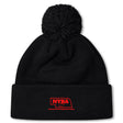 The Nebraska Youth Rugby Association Pom Pom Beanie by EMB Canterbury features a black knit design, cozy fleece lining, pom-pom top, and a red embroidered NYRA logo with a Nebraska outline on the folded brim.