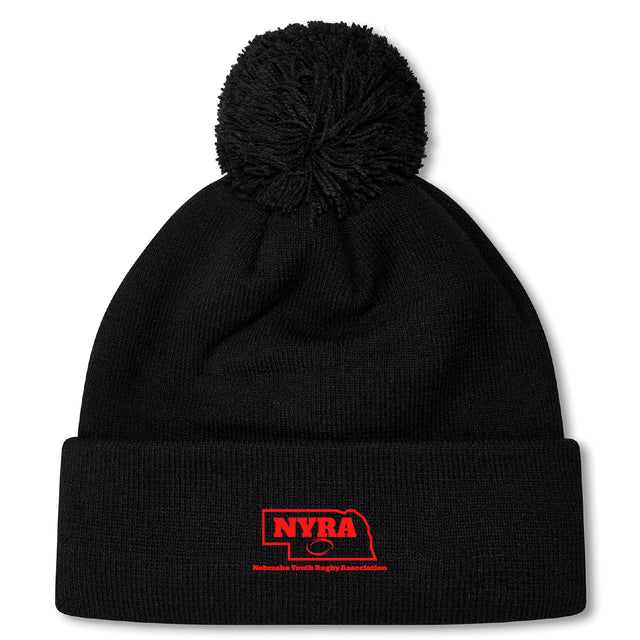 The Nebraska Youth Rugby Association Pom Pom Beanie by EMB Canterbury features a black knit design, cozy fleece lining, pom-pom top, and a red embroidered NYRA logo with a Nebraska outline on the folded brim.