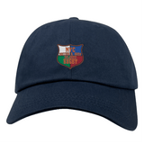 The EMB S&S Activewear NYC British and Irish Selects Adult Low-Profile Cotton Twill Dad Cap is a navy blue hat featuring a shield-shaped, multicolored embroidered "NYC British & Irish Selects Rugby" team logo.