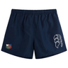 The NYC British and Irish Selects Tactic Short by Canterbury in navy blue offers style and comfort with a white logo on the right and a colorful emblem on the left.