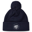 Stay warm on chilly days with the League of Gentleman Adventurers Pom Pom Beanie by EMB Canterbury—a navy blue, fleece-lined rugby hat with a folded brim, white "LOGA" logo, and pom-pom on top.