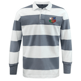 The NYC British and Irish Selects Classic Long Sleeve Hooped Rugby Jersey by EMB Mudoo features blue and white stripes, made from a comfy cotton/poly blend, with a colorful embroidered chest patch, perfect for leisurewear.