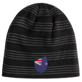 The New Zealand Shield Beanie from EMB Canterbury features black and gray stripes with a small shield displaying a stylized New Zealand flag.