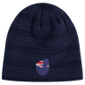 The New Zealand Shield Beanie by EMB Canterbury is a dark blue knit with subtle stripes and an emblem reminiscent of a stylized flag, featuring a red and white design on a blue background.