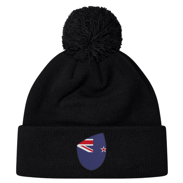 The New Zealand Shield Pom Pom Beanie by EMB Canterbury in black combines warmth with national pride, featuring a stylish badge.