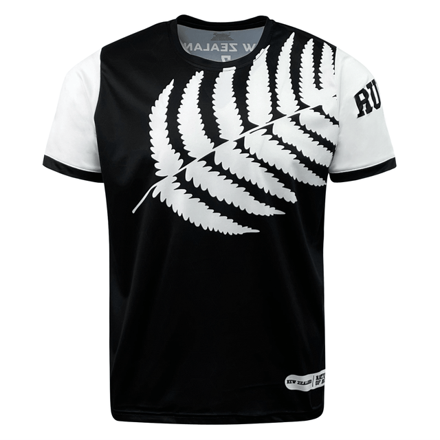 A black and white t-shirt featuring a large white fern leaf design across the front, with "New Zealand" text partially visible at the collar and "Rugby" text on the right sleeve, this **Nations of Rugby New Zealand 7s Rugby Flag Supporters Jersey** by **Admiral** is perfect for 7s rugby supporters.